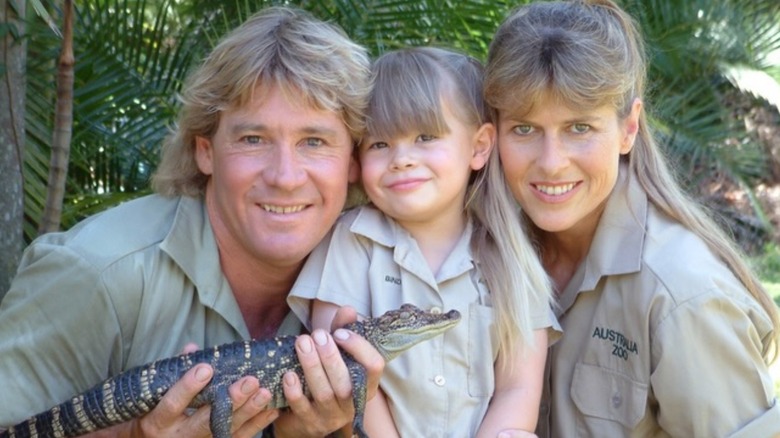 The Irwin family posing with a baby crocodile.