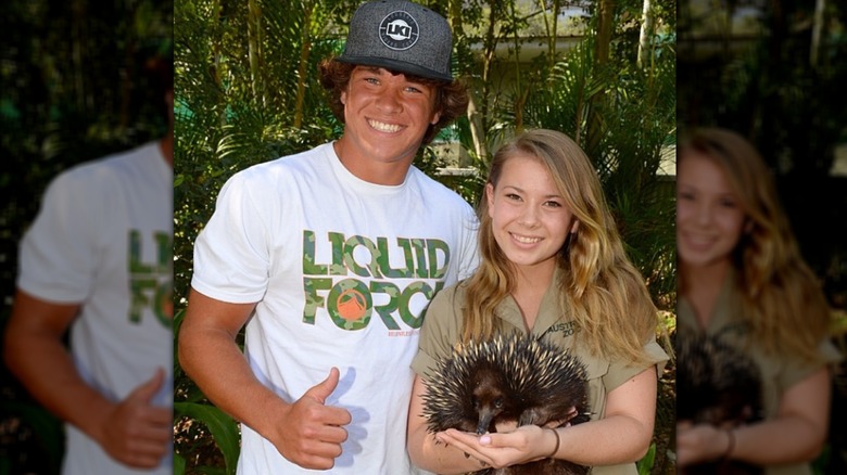 Chandler Powell giving a thumbs-up and Bindi Irwin holding an echidna.