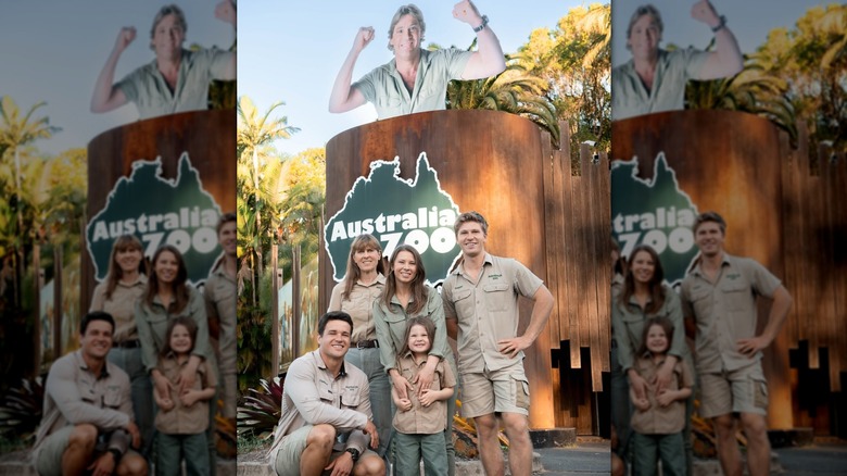 The Irwin family posing in front of an Australia Zoo sign.