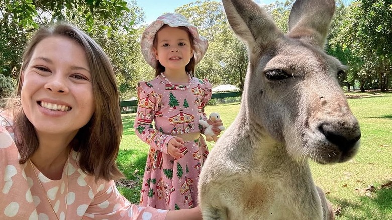 Bindi Irwin taking a selfie with a kangaroo and her daughter, Grace.