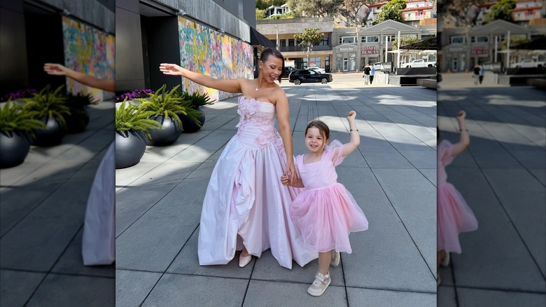 Bindi Irwin holds hands with Grace as they dance together in pink
