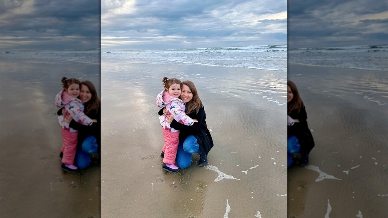 Bindi hugs daughter Grace by the ocean
