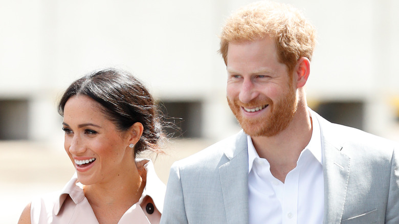 Meghan Markle and Prince Harry smiling and laughing