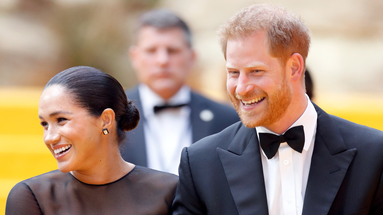 Meghan Markle and Prince Harry laughing in their finery