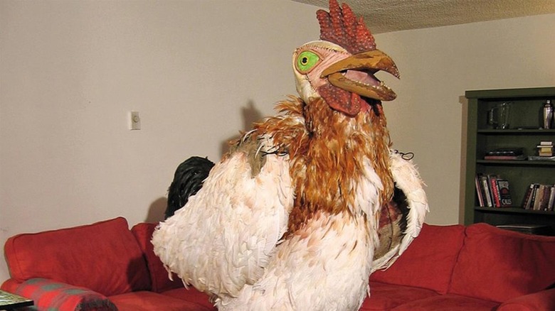 A man in a chicken suit stands at the ready