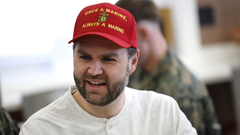 JD Vance smiling in a red Marines cap