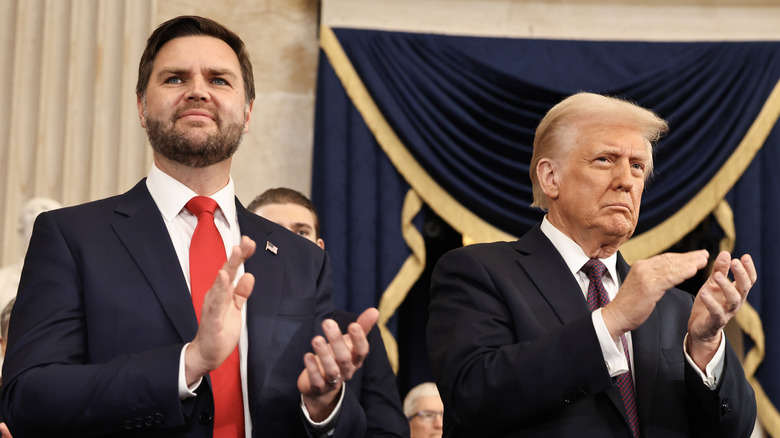 JD Vance and Donald Trump clapping in suits