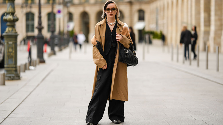 woman in brown coat and black pants