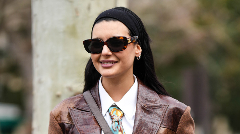 woman wearing black headband and leather blazer