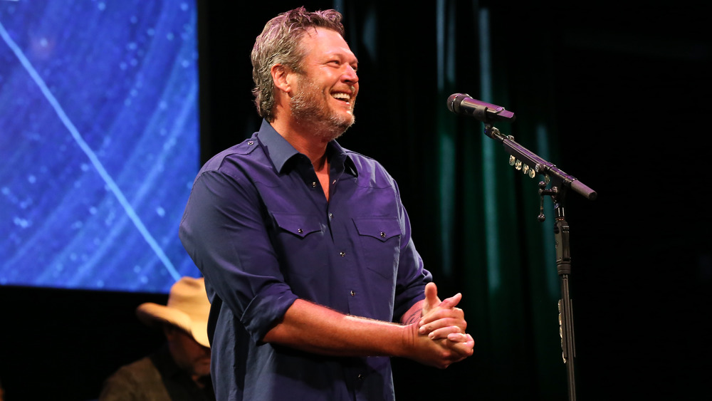 Blake Shelton smiling during a performance 