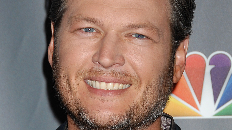 Blake Shelton poses with a smile.