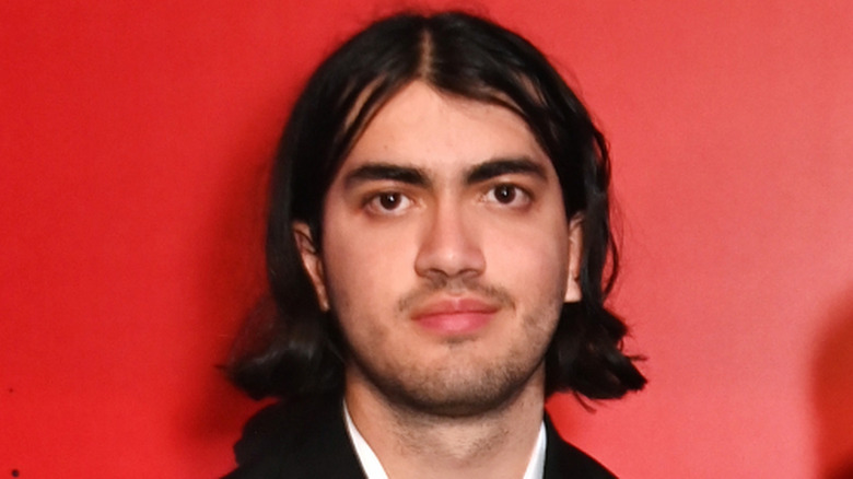Bigi Jackson posing in front of a red wall