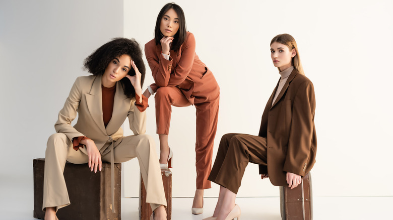 three women in suits with blazers