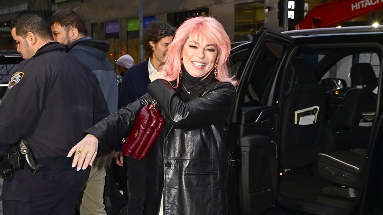 Shania Twain wearing black with pink hair and bangs in New York City