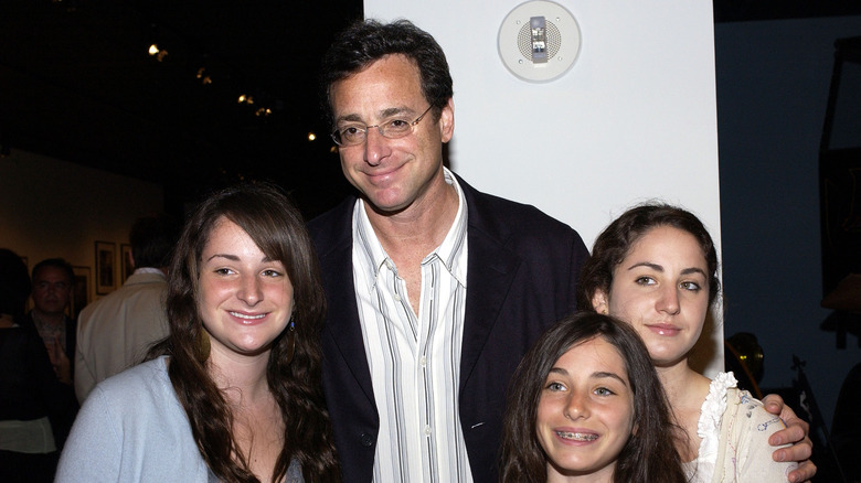 Bob Saget and his daughters, smiling