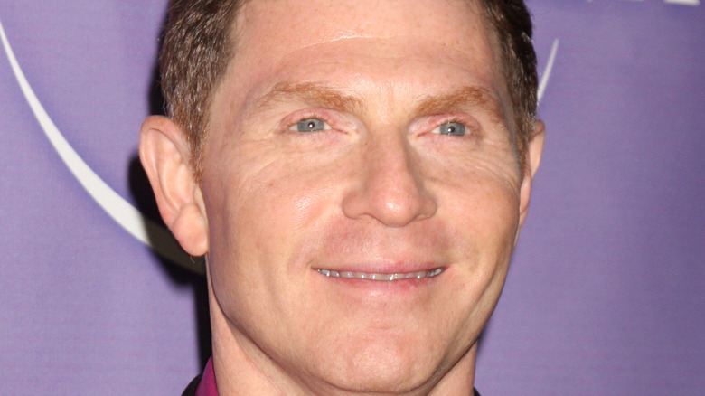 Bobby Flay smiling on Universal red carpet