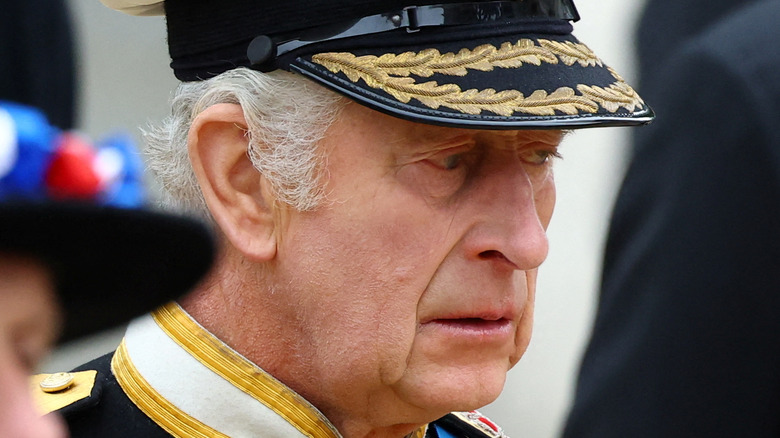 King Charles III looking sad at Queen Elizabeth II's funeral