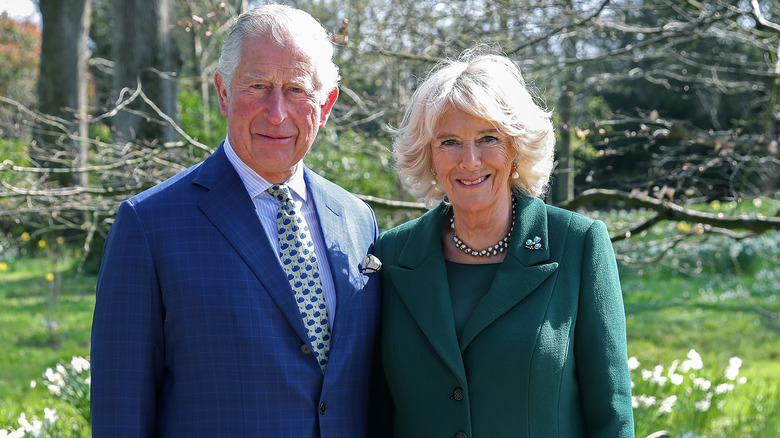 King Charles and Queen Camilla posing in garden