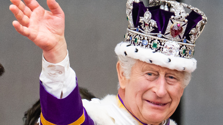 King charles in his crown waving