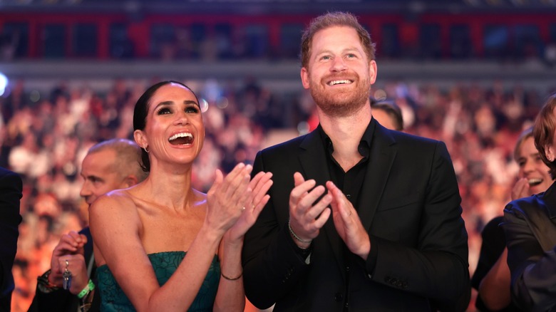 Meghan Markle Prince Harry smiling, clapping
