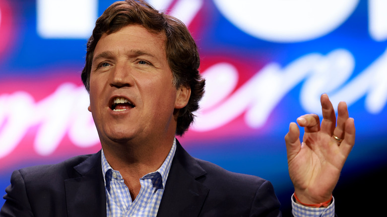 Tucker Carlson gesturing and facially animated