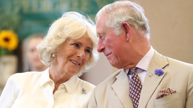 Charles and Camilla with their heads together 