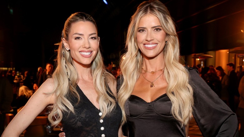 Heather Rae El Moussa and Christina Haack smiling and posing for a picture