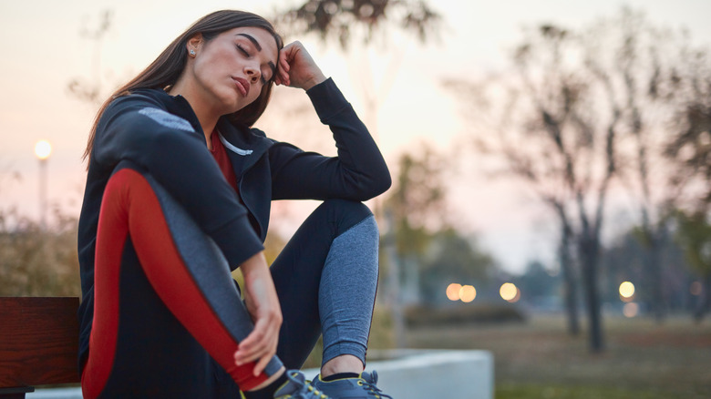 Bored woman taking a break from exercise