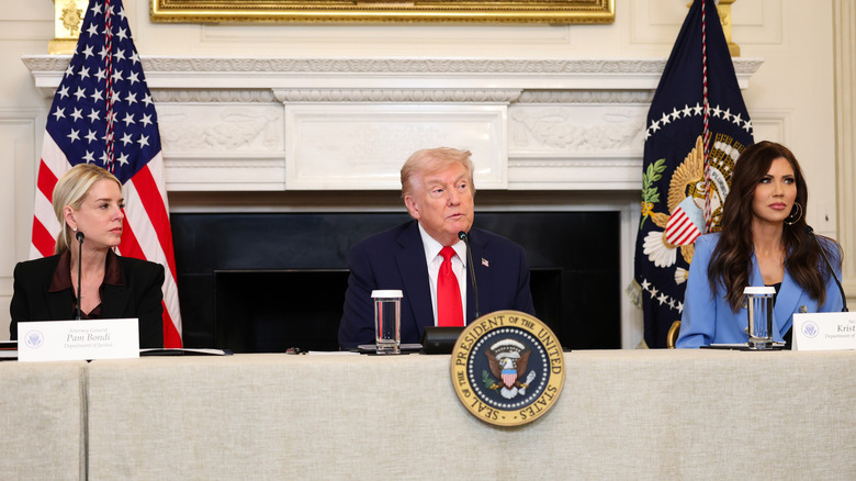 Pam Bondi, Donald Trump, and Kristi Noem sitting together