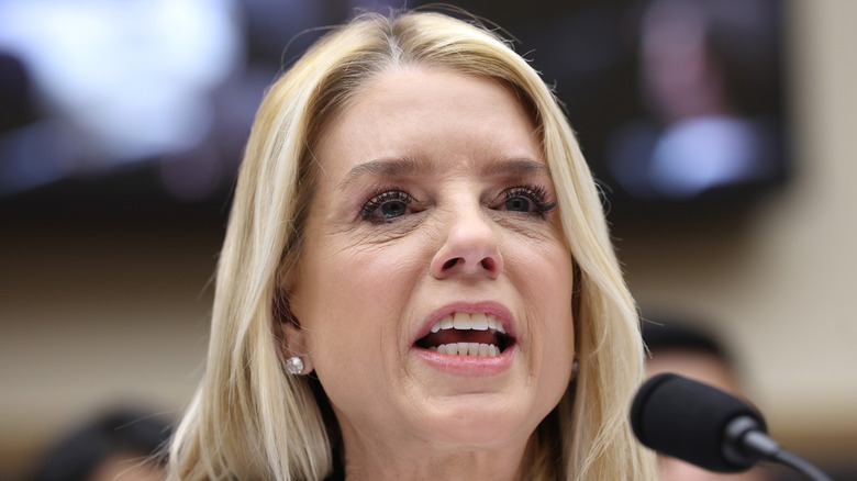 Pam Bondi shouting into microphone