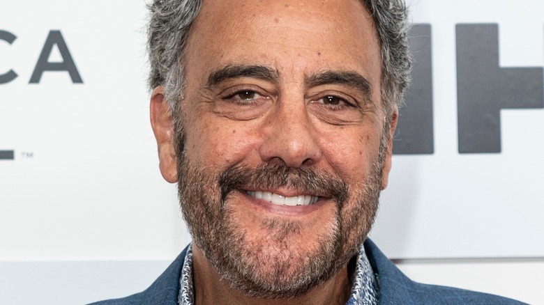 Brad Garrett smiling in suit on red carpet