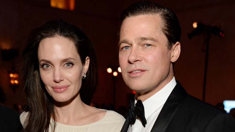 Angelina Jolie and Brad Pitt posing for photos