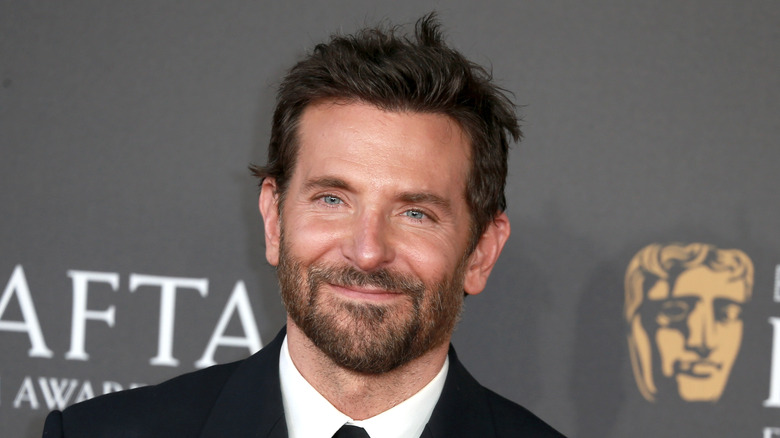 Bradley Cooper smiling in a suit.