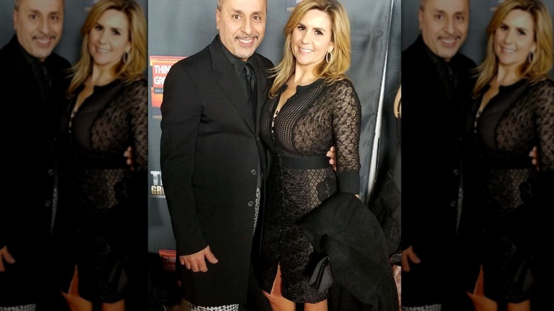 Brandi Passante poses next to a fan in a black lace dress