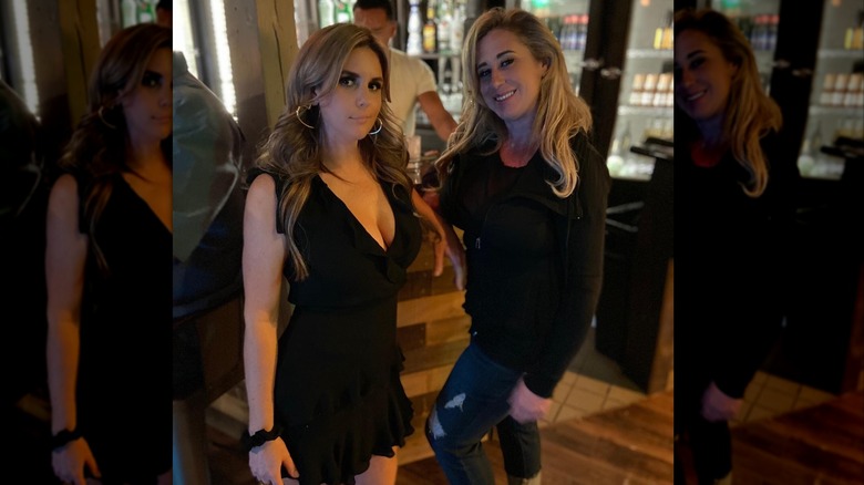 Brandi Passante stands next to a friend wearing a v-neck little black dress