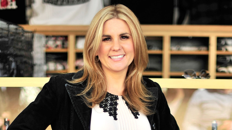 Brandi Passante smiles in a black blazer in front of her thrift store