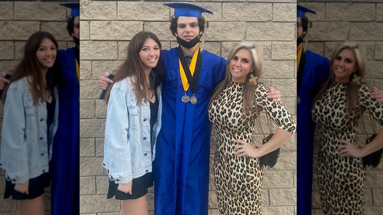 Brandi Passante poses next to her kids at her son's graduation wearing a cheetah print dress