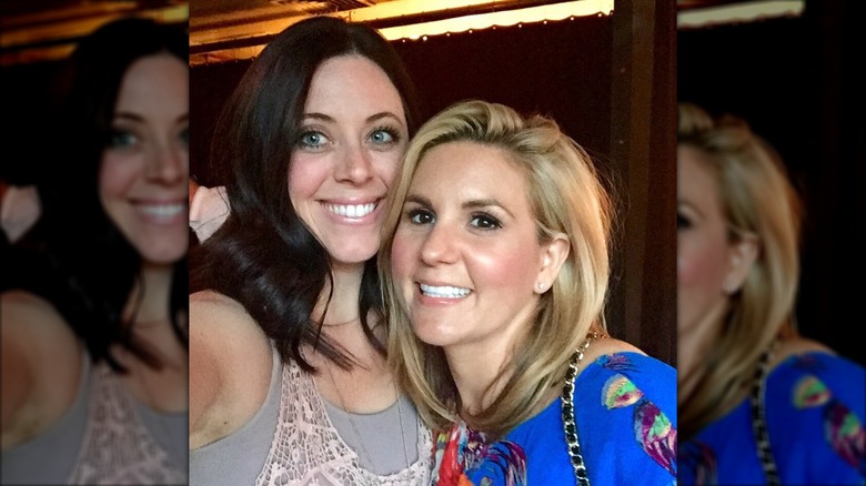 Brandi Passante in a blue shirt cuddling up with female pal.