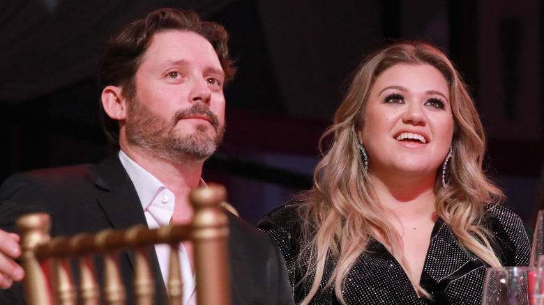 Brandon Blackstock and Kelly Clarkson smiling at an event