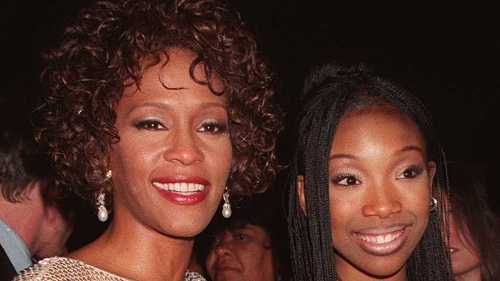 Whitney Houston and Brandy hugging and smiling