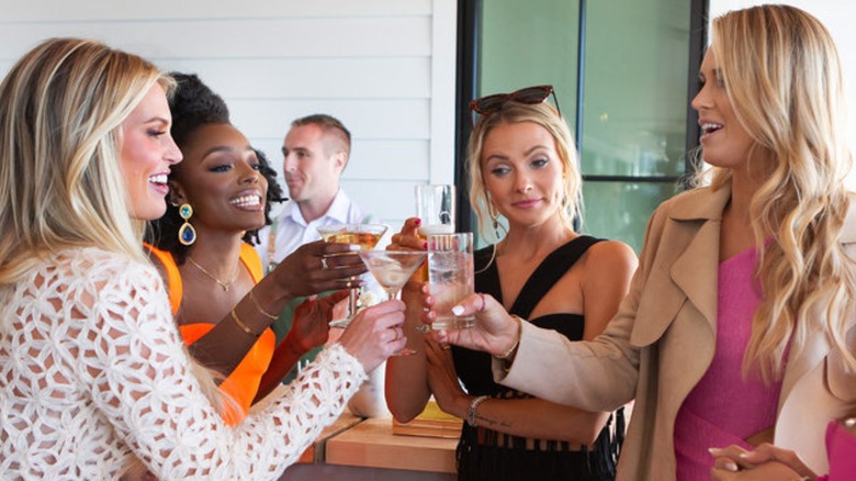 Madison LeCroy, Venita Aspen, Taylor Ann Green, Olivia Flowers raising their glasses