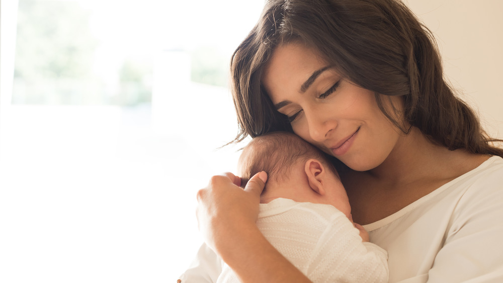 Woman hugs baby