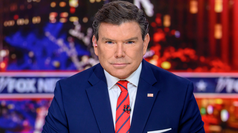 Bret Baier with a serious expression, sitting behind a Fox News desk