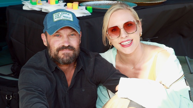 Brian Austin Green and Sharna Burgess smile for a photo.