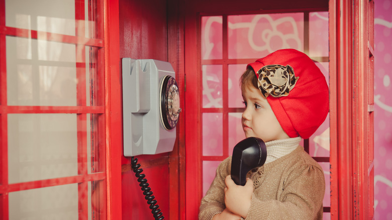 Child in London phone booth