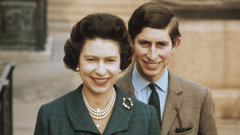 King Charles smiling in a military uniform