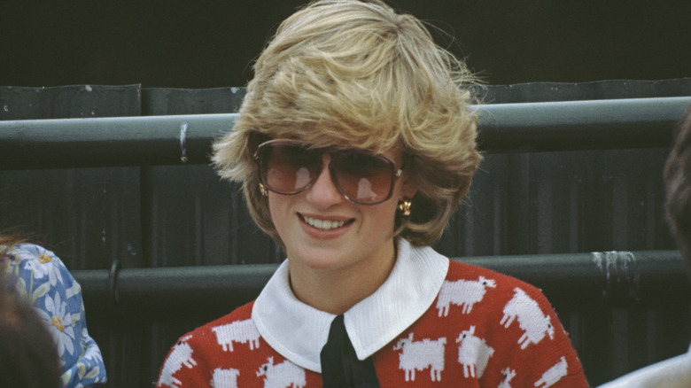 A smiling Princess Diana wearing sunglasses