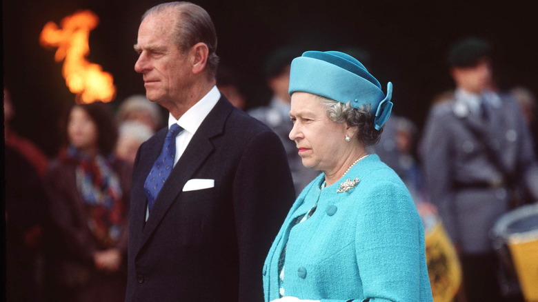 A grave-looking Prince Philip and Queen Elizabeth II