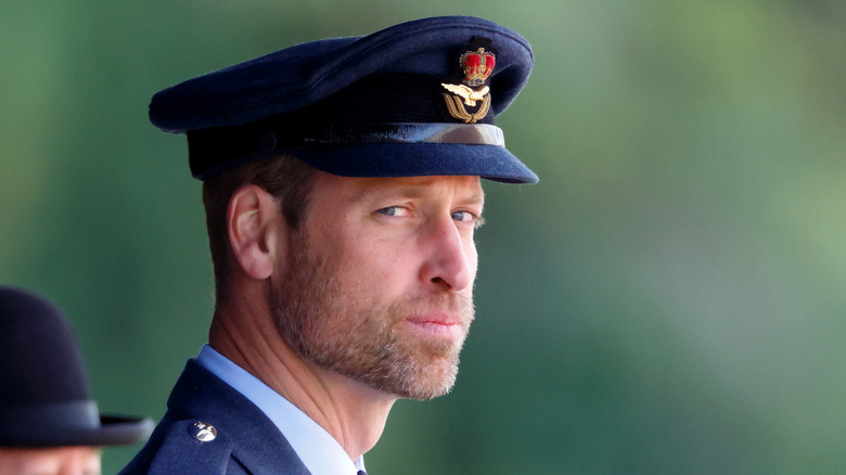 Prince William looks sternly at the camera while dressed in military clothes