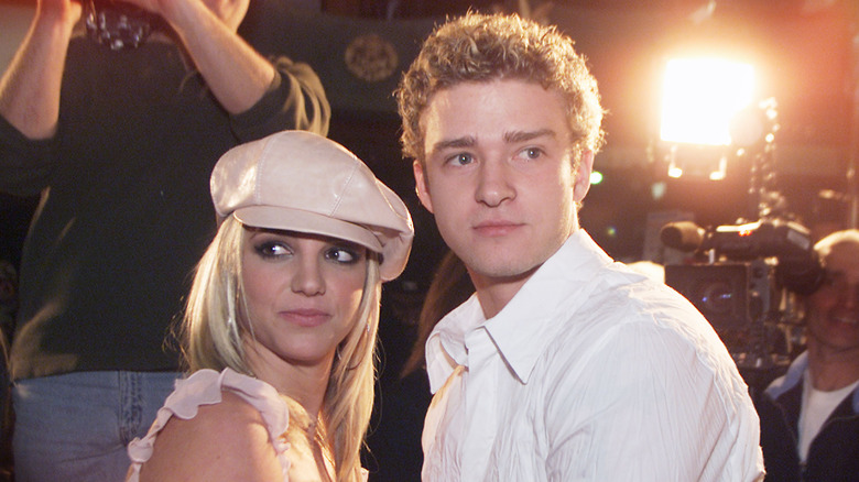 Britney Spears and Justin Timberlake posing in front of paparazzi